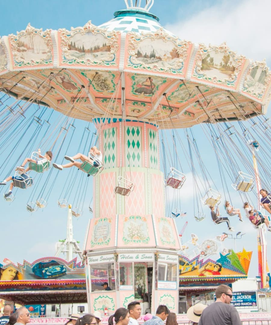 A colourful swing ride spinning at a theme park